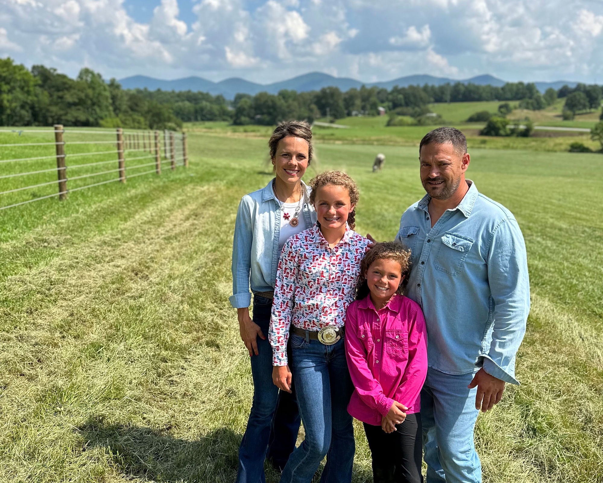 Clayton Llewellyn and his family at their North Carolina property with Cameo Fencing visible in the background